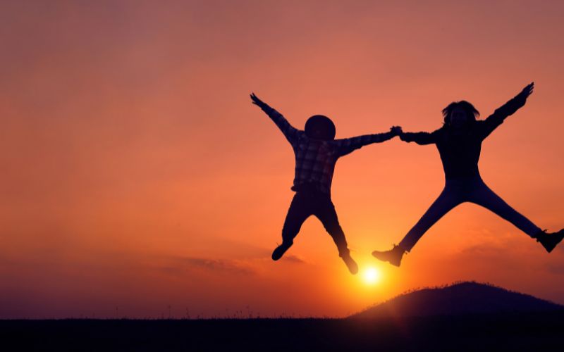 two people jumping into the new year